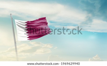 Qatar national flag waving in beautiful sky.