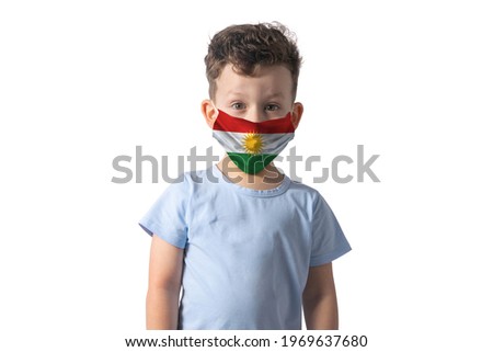 Respirator with flag of Kurdistan. White boy puts on medical face mask isolated on white background.