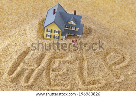 House sinking in quick sand with for rent sign and word help written in sand, real estate crisis concept, foreclosure assistance and challenges of home ownership conceptual photo