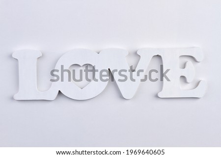 Plastic white word LOVE isolated on white background.