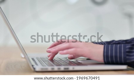 Side View of Woman Typing on Laptop
