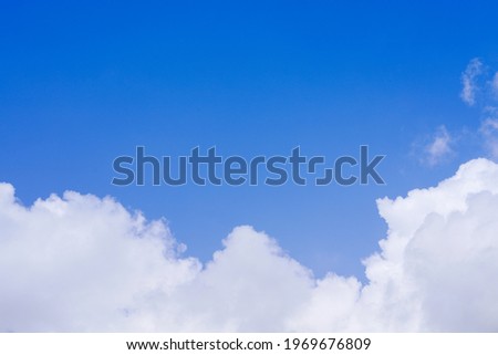 textured white cumulus clouds in the blue sky