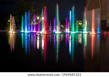 Long exposure of a colourful outdoor fountain - water and light moving to the music - unique shopping experience in Merida, Mexico
