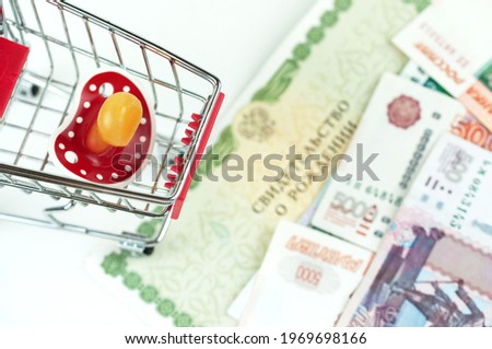 Russian money and a dummy, the concept of increasing fertility in Royalty-Free Stock Photo #1969698166