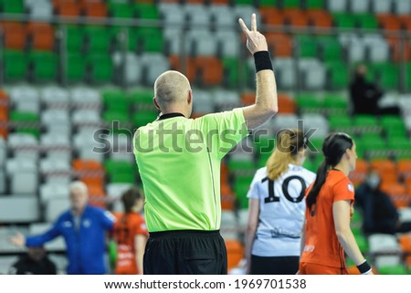 Referee shows two minutes of punishment during women handball match