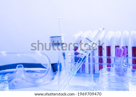 Focus on Coronavirus vaccine in ready to shot filling syringe with Covid 19 cure from vial, extreme macro. Concept of administration medication with sterile medical needle syringe injection. One dose.