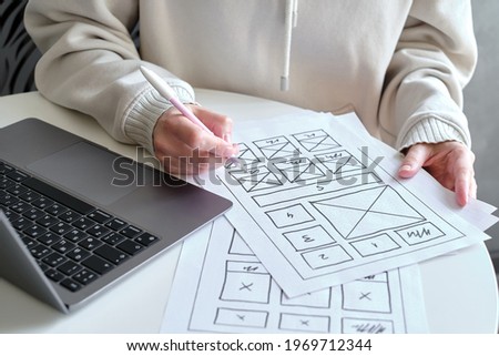 Woman designer create website design wireframe. Sketch, prototype, framework, layout future design project. UI and UX - user interface, user experience designer. Creative concept for web design studio Royalty-Free Stock Photo #1969712344