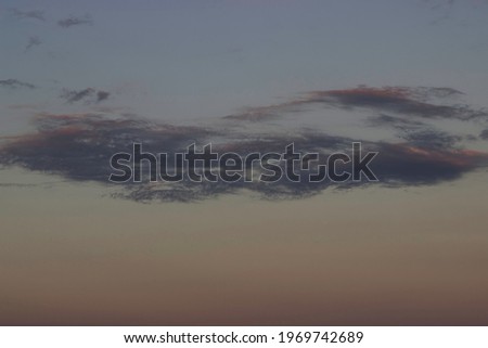 Cloud on the background of the sunset sky.