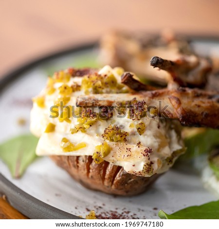 Baked meat on bone with potatoes. Soft focus, close up shot. Food concept. Square format or 1x1 for posting on social media.