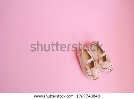 Cute baby girl shoes isolated, pink background