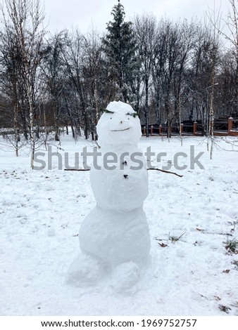 Snowman in Park. Snowy Day in Park.