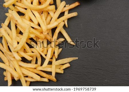 french fries fast food on a slate plate top view close-up horizontal photo with place to insert