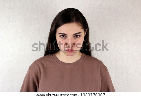 Offended girl. Girl with puffy cheeks with resentment emotion