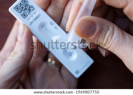 Close up of a person using coronavirus covid-19 rapid antigen home testing kit Royalty-Free Stock Photo #1969807750