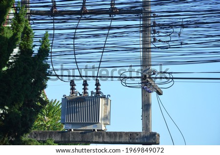 a power tranformer and a power cable Royalty-Free Stock Photo #1969849072
