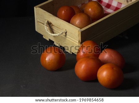 tomatoes in wooden box and glass containers