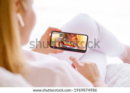 Woman watching cooking video on mobile phone