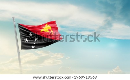 Papua New Guinea national flag waving in beautiful sky.