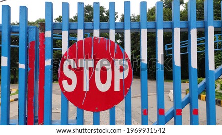 Stop signboard hanged on the fence