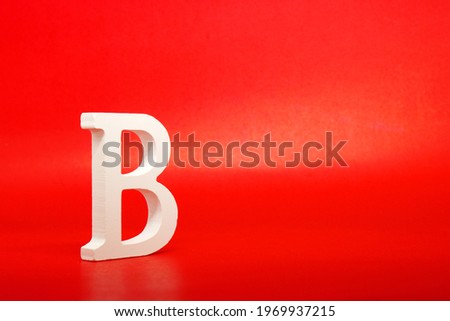 B white letter word wooden Isolated Red Background with Copy Space - Advertise object symbol or the second grade competition Concept 