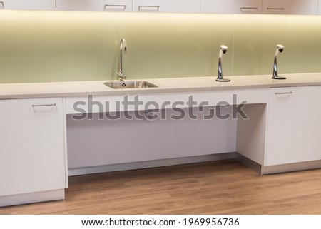 Modern Kitchen interior with shallow depth sink for wheelchair access. Royalty-Free Stock Photo #1969956736