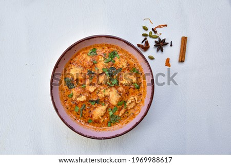  Thai Red Fish (Prawn, Chicken) curry. Brazilian food: Moqueca Baiana of fish and bell peppers in spicy coconut sauce close-up on a plate on a table. horizontal top view from above