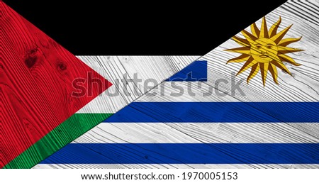 Flag of Palestine and Uruguay on wooden planks