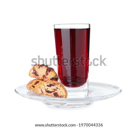 Tasty cantucci with berries and glass of liqueur on white background. Traditional Italian almond biscuits