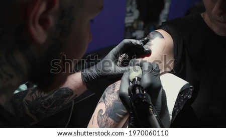 Photo of doing black tattoo of snake for woman