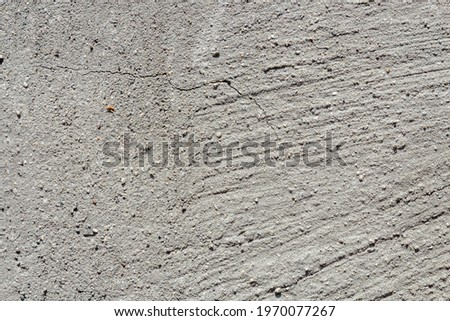 Aged concrete texture under natural light for backgrounds and substrates.