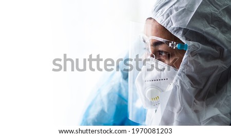 woman doctor in PPE (Personal Protective Equipment) for working in Covid19 ward and treatment hight risk case Royalty-Free Stock Photo #1970081203