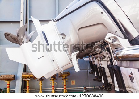 Motor propellers for motor yachts and boats close-up. The motors are mounted at the stern of the motor boat. Repair a boat in a dry dock. Royalty-Free Stock Photo #1970088490