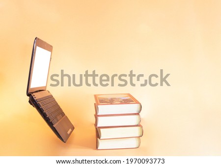 Black notebook books on orange background