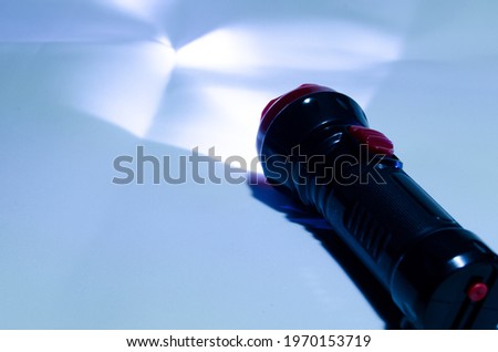 Small hand-held photo flashlight. Photo of a lantern on a white background