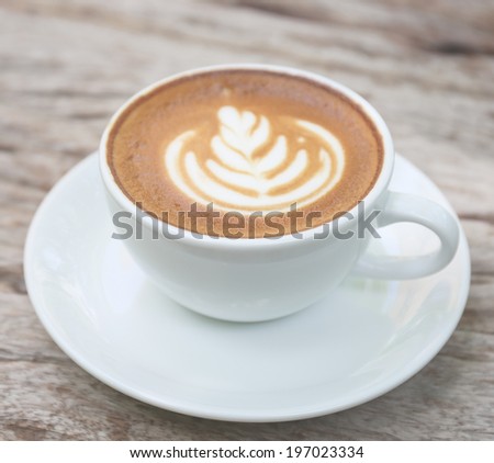 Latte art on wooden background