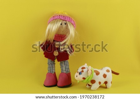hand made doll on the yellow background