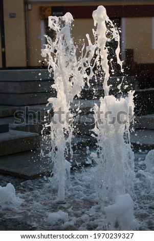 A column of water coming out of the fountain.