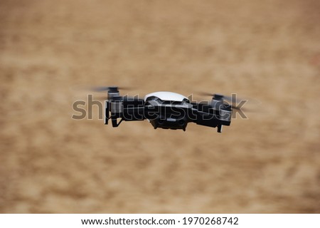 A selective focus shot of a quadcopter in flight