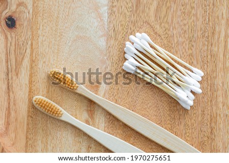 environmentally friendly bamboo and cotton cotton buds on a pink background, bamboo toothbrushes for adults and children. human personal hygiene products without harming the environment, biodegradable