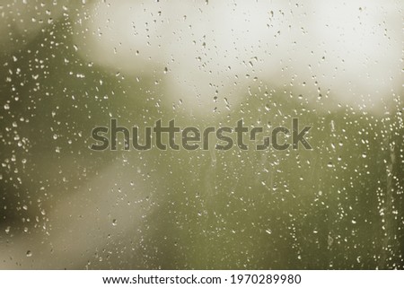 A closeup shot of waterdrops on a glass