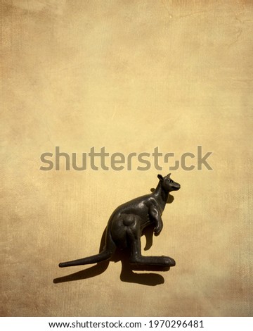 A closeup shot of a toy kangaroo on brown background