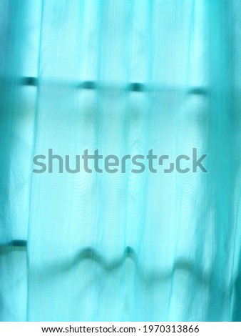 The patterns of the curtains reflect the shadows in the morning sunlight.