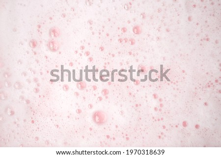White foam bubbles texture on pink pastel background, copy space, banner for loundry, cleaning service, bathroom concept, clean, wash - liquid soap, shower gel, shampoo