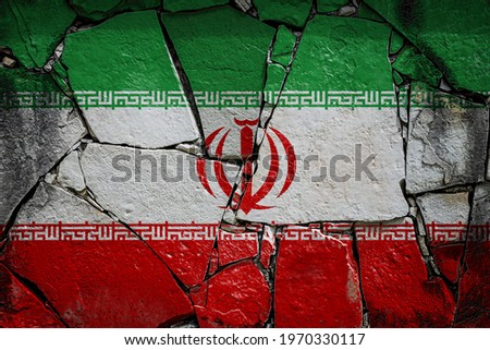 National flag of Iran
 depicting in paint colors on an old stone wall. Flag  banner on broken  wall background.