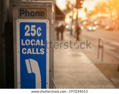 Old pay phone detail with city street in the background Royalty-Free Stock Photo #197034653
