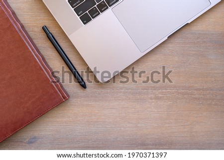 Office table with laptop, pen and notebook. Top view with copy space