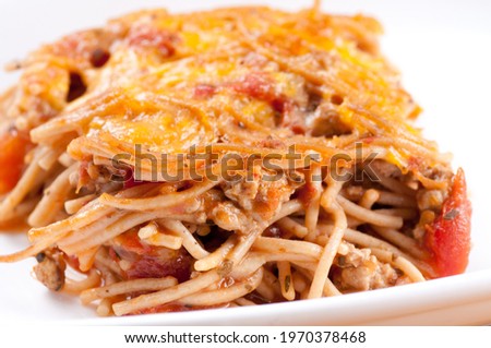 baked spaghetti with crusted gooey cheese and tomato