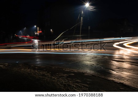 night photo of blurred light from car headlights at the intersection