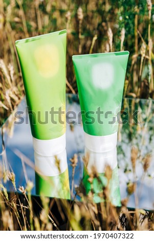Tubes of cream in a field on a mirror surface