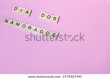Top view dia dos namorados(Valentine's Day) lettering of alphabet wooden blocks on pink background with free space